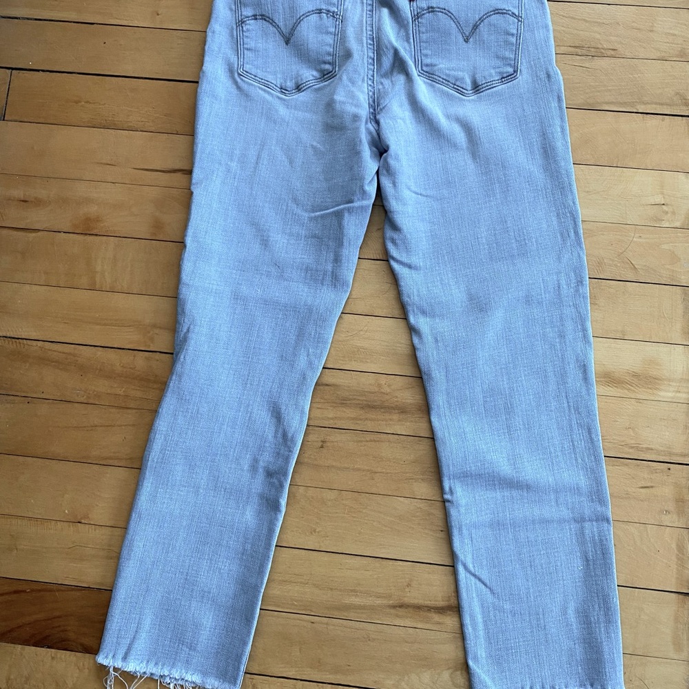 Levi’s slimming skinny distressed light wash jeans